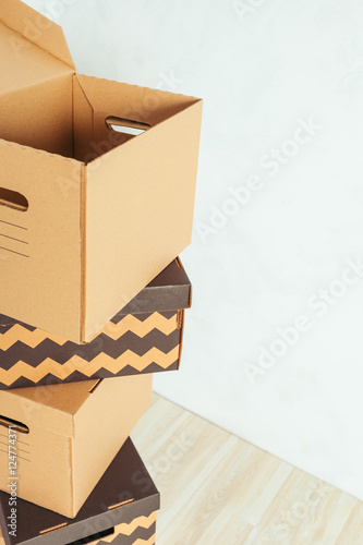 Big cardboard boxes standing insinde a room photo