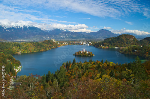 View of the castle and of the Church of the Assumption in the island of the Lake of Bled (Blejsko jezero) with the Karawanks Alps in the background, Slovenia 