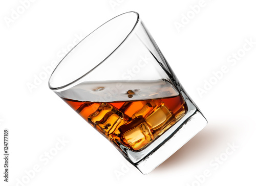 Canvas-taulu Whiskey with ice in a tilted glass
