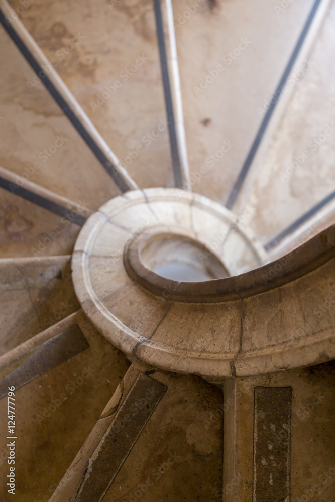 Fototapeta premium antique spiral ladder from marble stone