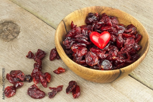 Dried cranberries in a bowl. Healthy superfood. Dried cranberries on the kitchen table. Diet food.
