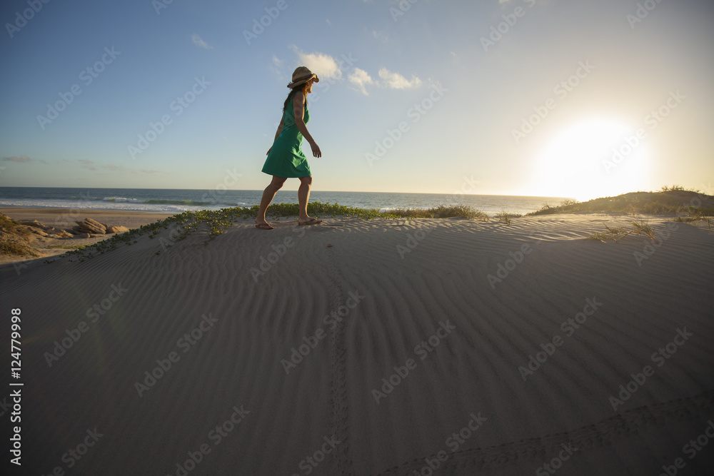 Fototapeta premium An adult woman playing on the beach at Conejo in Baja California del Sur, Mexico.