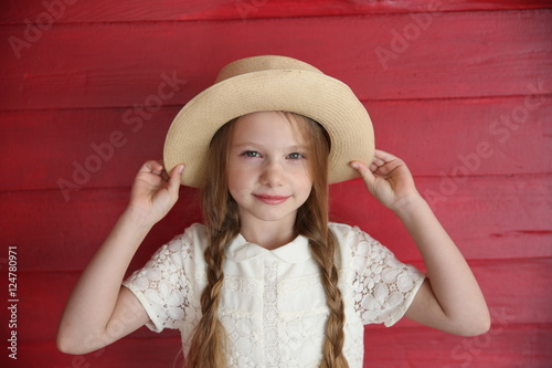 red-haired girl wearing white dress with a hat