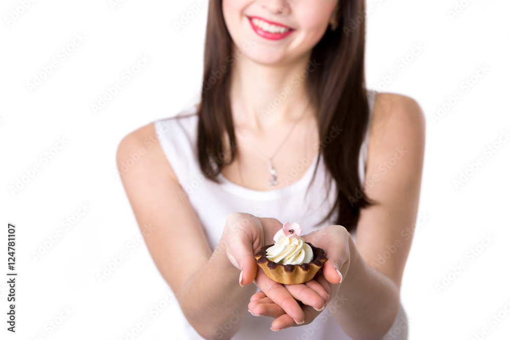 Young woman holding a cake, closeup