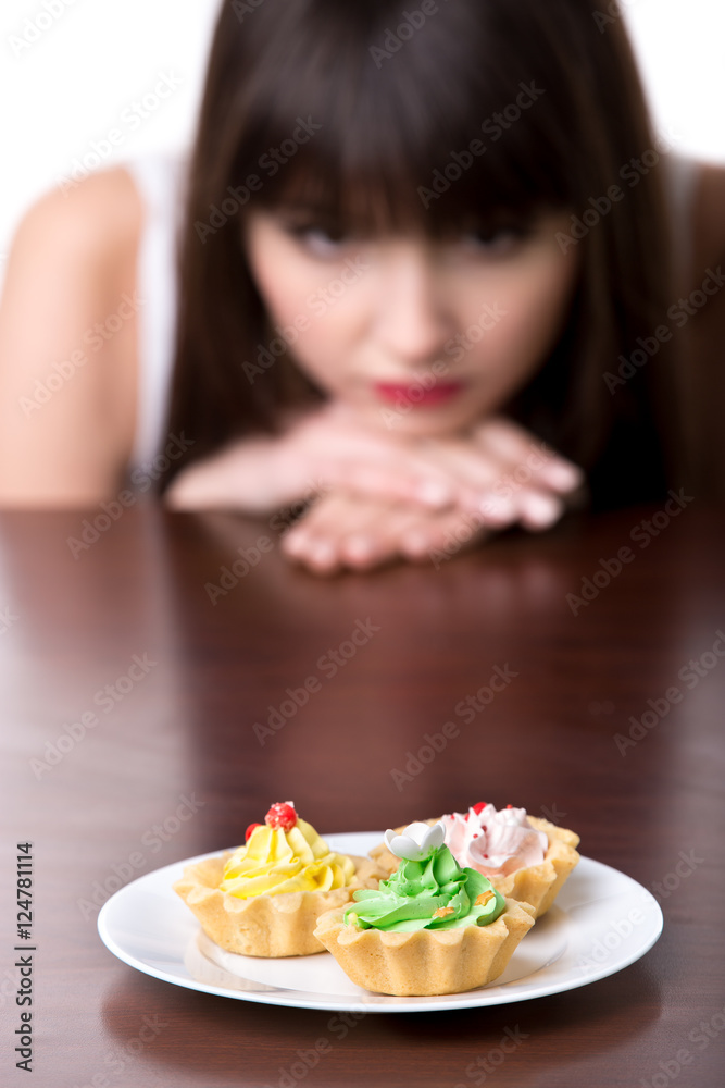 Dieting woman longing for cake Dieting woman longing for cake