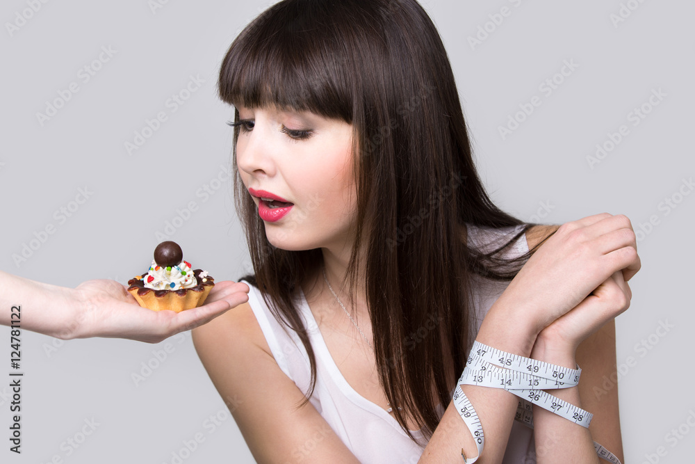 Dieting young woman with sweet tooth Dieting young woman with sweet tooth