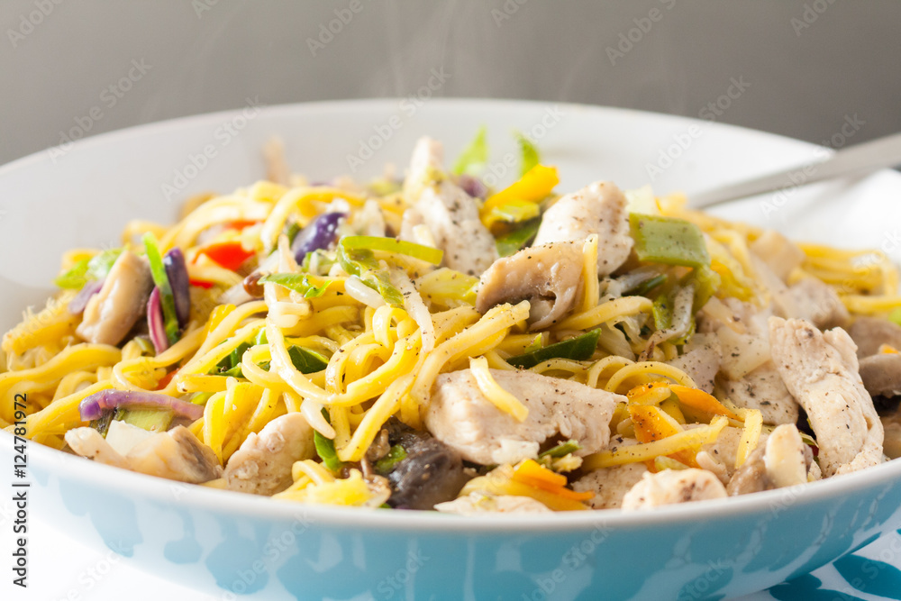 Close-up view of stir-fried chicken and vegetables served with noodles Close-up view of stir-fried chicken and vegetables served with noodles