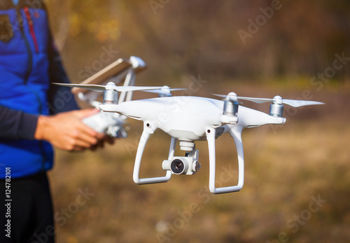 Man operating drone flying by remote control