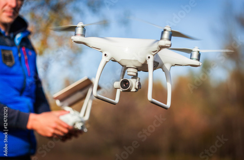 Man operating drone flying by remote control