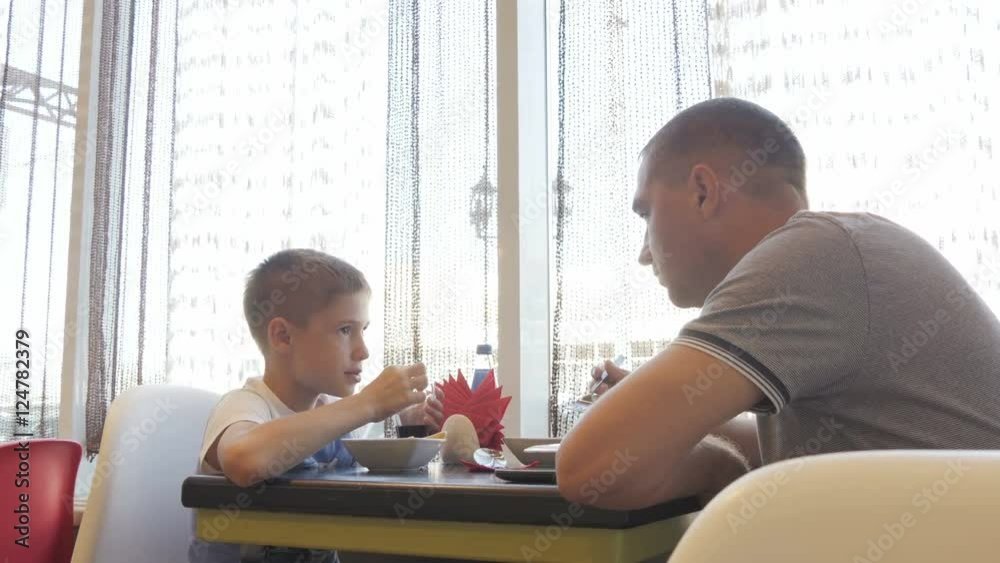 with his son in the cafe at lunch father with his son in the cafe at lunch father