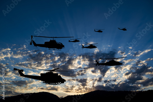 Fototapeta Naklejka Na Ścianę i Meble -  Flying army helicopters on sunset background