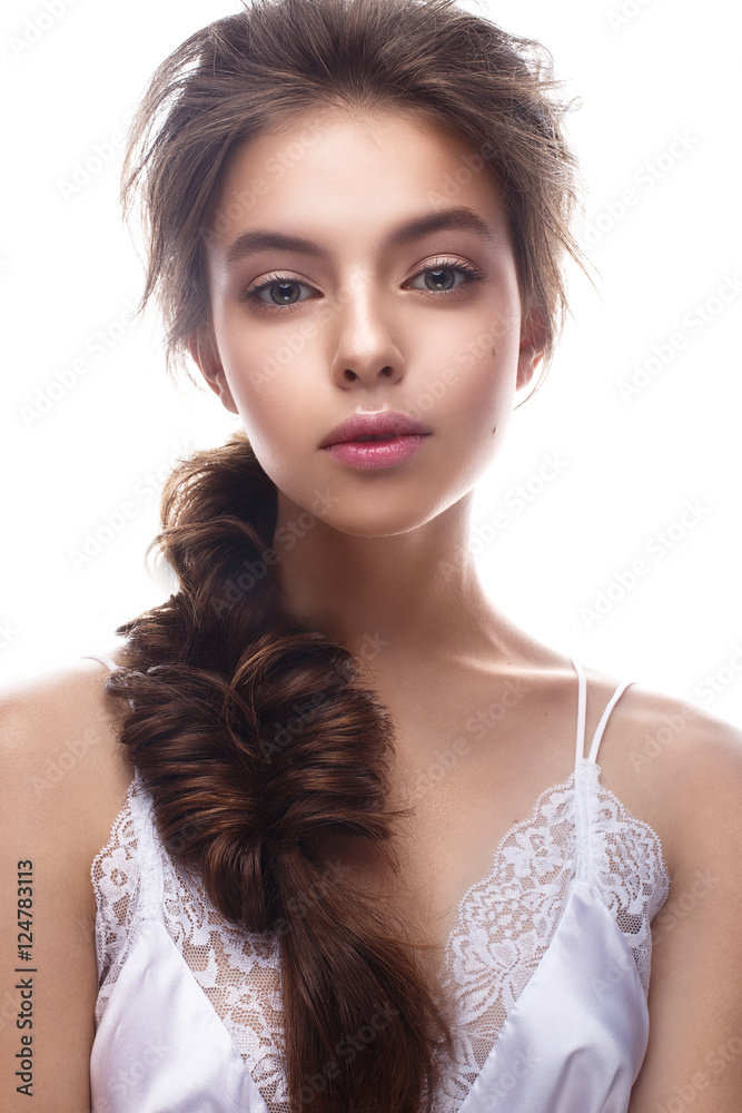 Beautiful girl in image of bride with plait. Model with nude makeup and silk underwear. Beauty face. Photo was taken in a studio.