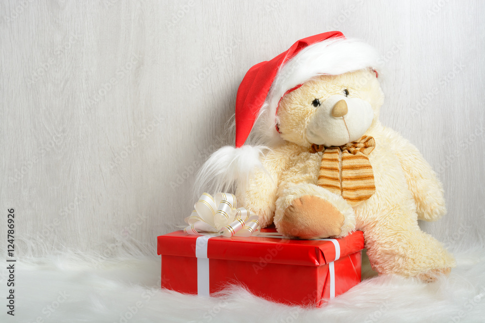 Teddy bear in santa hat with gifts