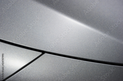 Surface of metallic sport sedan car, detail of metal hood and fender of vehicle bodywork
