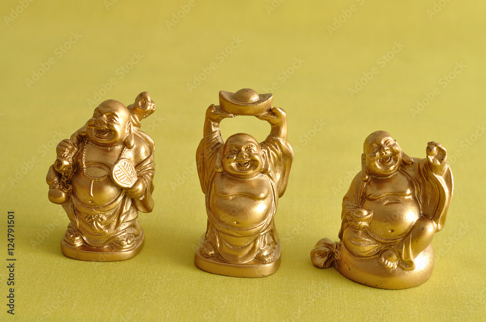 Figurines of a laughing and cheerful golden Buddhas Figurines of a laughing and cheerful golden Buddhas