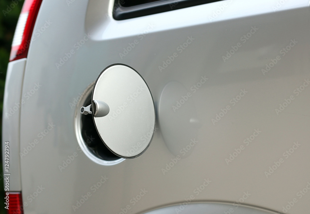 Opened gasoline tank cover on silver car Opened gasoline tank cover on silver car