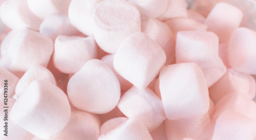 Pastel pink marshmallows background with an intentional blur effect applied. Pastel pink marshmallows background with an intentional blur effect applied.