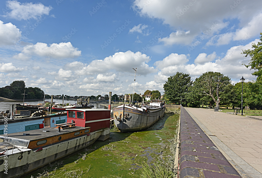 Thames Path with boats docked along the river in Hammersmith.