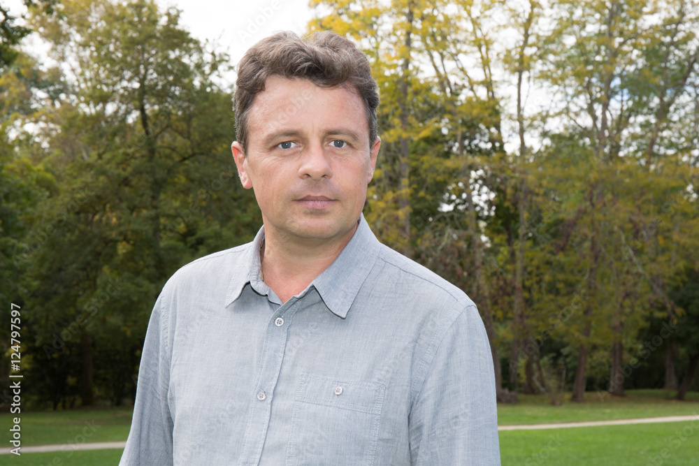 Cheerful man outdoors in fall clothing with autumn natural surroundings Cheerful man outdoors in fall clothing with autumn natural surroundings