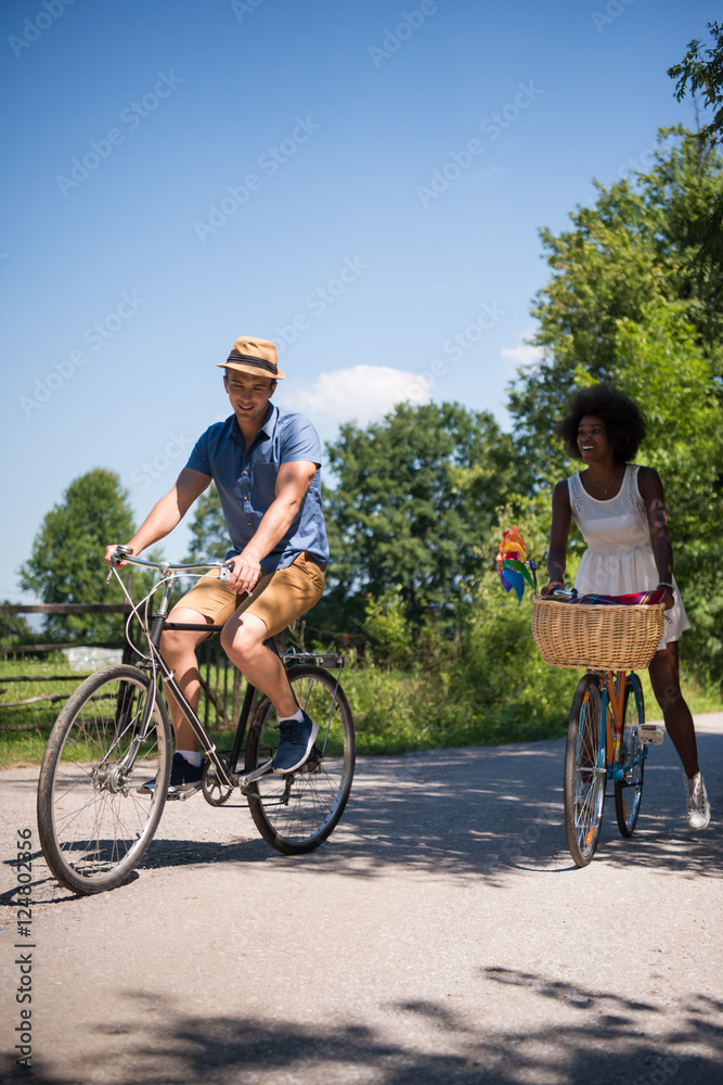 Fototapeta premium Young multiethnic couple having a bike ride in nature