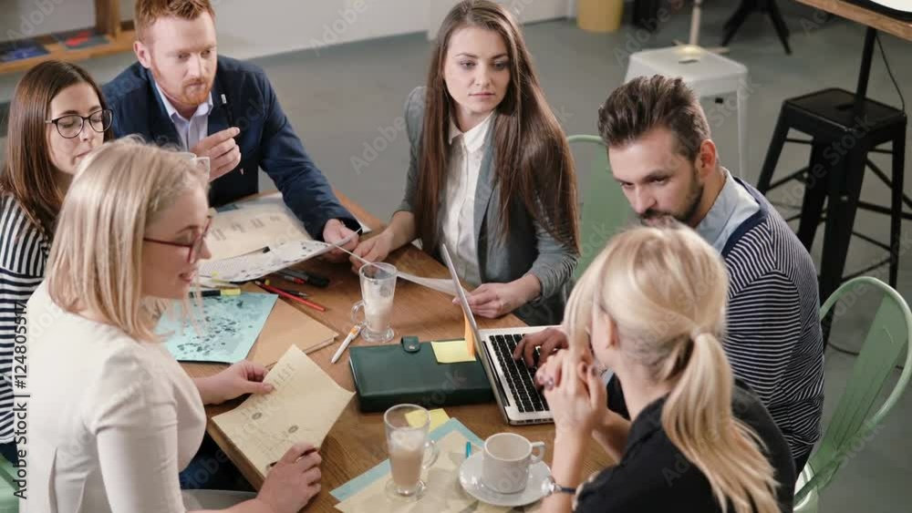Creative business team at the table in a modern startup office. Female leader explains the details of the project. Creative business team at the table in a modern startup office. Female leader explains the details of the project.