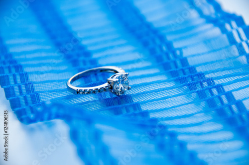 Silver ring with cubic zirconia on the blue ribbon   photo