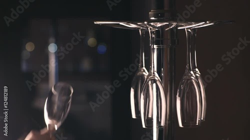 female hand takes a wine glass from stand