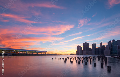 Golden hour in Brooklyn New York looking at a Brooklyn dock on the left and lower Manhattan on the right