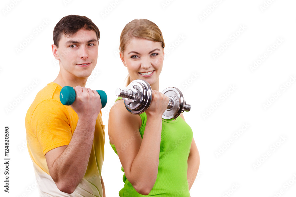 Couple exercising with dumbbells lifting weights Couple exercising with dumbbells lifting weights