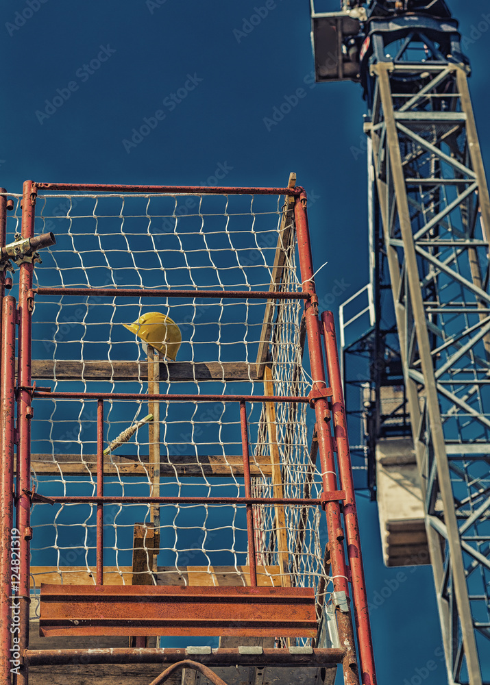 Protective yellow helmet on scaffolding