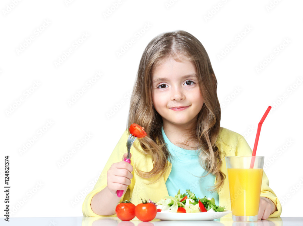 Child eats vegetables drinks juice isolated on white. Child eats vegetables drinks juice isolated on white.
