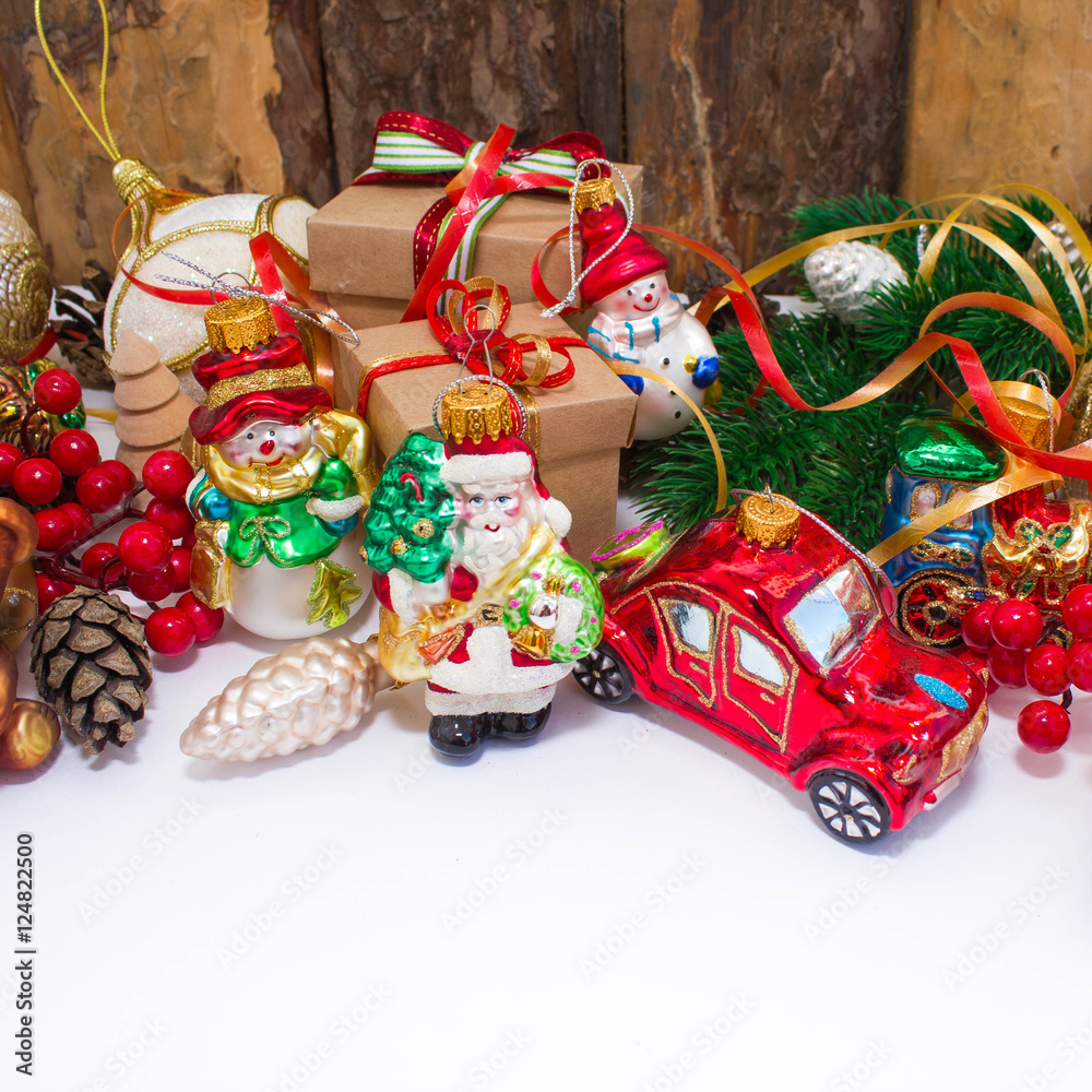 Christmas or New Year background: fur-tree, branches, gifts, colored glass balls and toy, decoration and cones on a white background