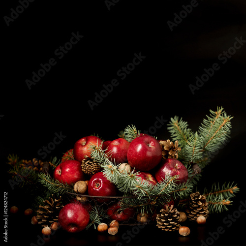 Christmas and New year. Apples with pine cones and nuts in a bas