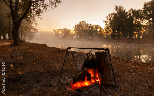 Bonfire on the background of the misty morning photo