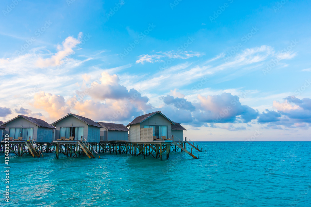Beautiful sunrise with  water villas  in tropical Maldives islan