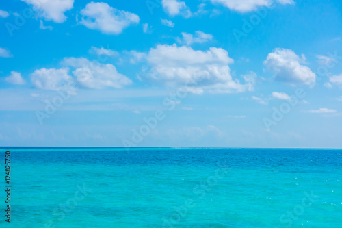 White clouds with blue sky over calm sea in tropical Maldives i