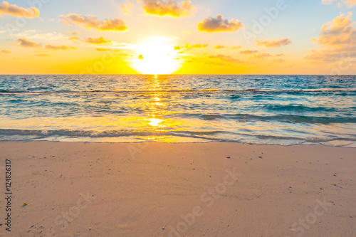 Beautiful sunset with sky over calm sea in tropical Maldives is