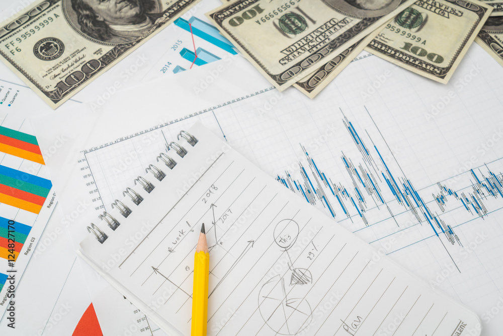 Financial charts on the table with dollars banknotes . Financial charts on the table with dollars banknotes .