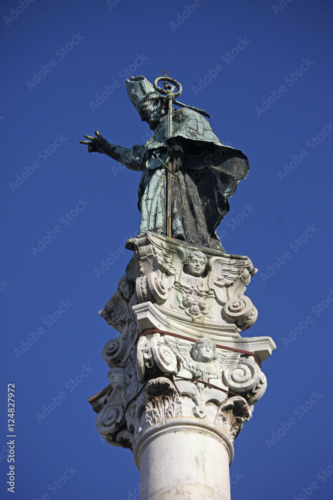 pope statue on pillar