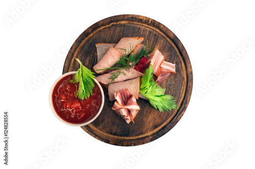 Meat cold cuts, cured sliced pork on wooden board with red chili sauce, ketchup, salsa sauce. Isolated on white.