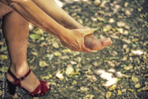 woman takes off a sandal © Vivida Photo PC