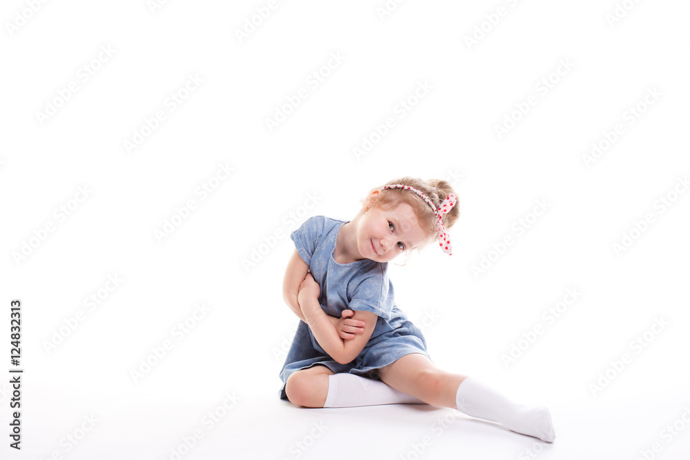 Closeup image of a pretty little girl sitting on the floor. Closeup image of a pretty little girl sitting on the floor.