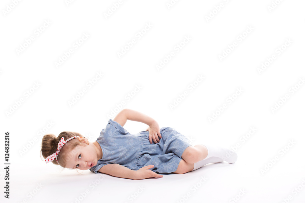 Closeup image of a pretty little girl sitting on the floor. Closeup image of a pretty little girl sitting on the floor.