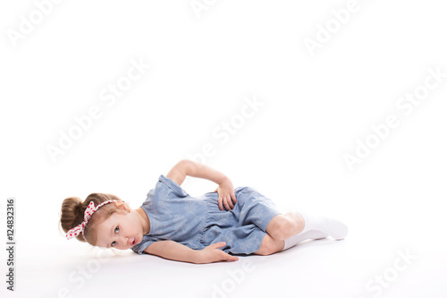 Closeup image of a pretty little girl sitting on the floor.