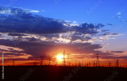 Many high voltage towers under the sunset © hanmaomin
