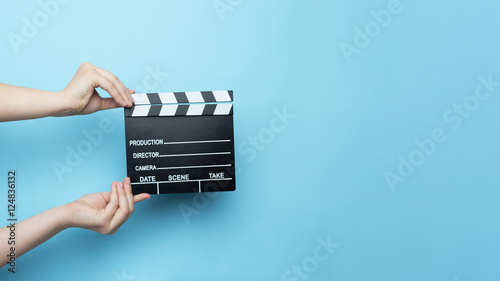 Tela movie clapper on blue background, cinema concept