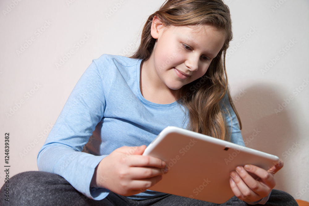 girl looking video on tablet and smiling girl looking video on tablet and smiling