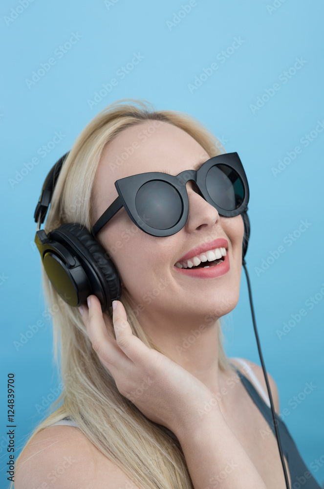 Young woman with headphones  listening to music and having fun a