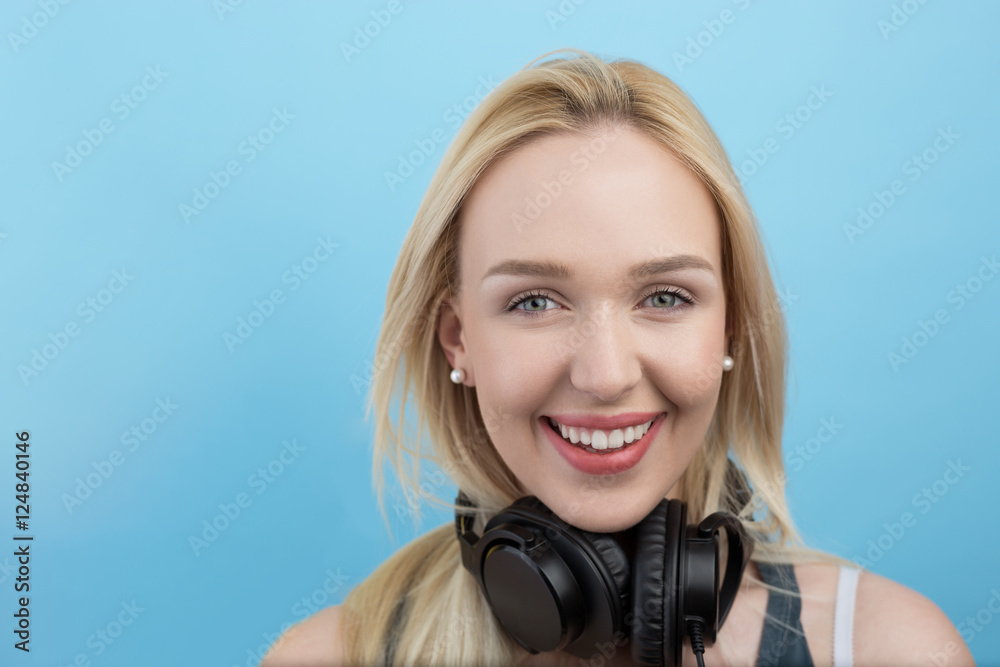 Fototapeta premium Young woman with headphones listening to music and having fun a