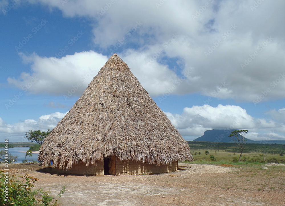Native landscape / native home built with mud and straw on the coast of the river Carrao, in the Venezuelan Gran Sabana, Canaima National Park Native landscape / native home built with mud and straw on the coast of the river Carrao, in the Venezuelan Gran Sabana, Canaima National Park